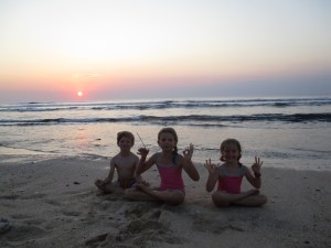 and little yogis in lotus pose by the ocean...